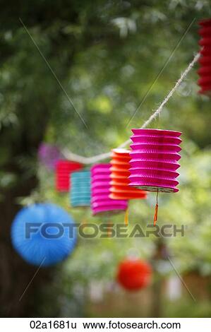 Paper lanterns hanging from a tree View Large Photo Image Stock Photograph - Paper lanterns hanging from a tree. Fotosearch