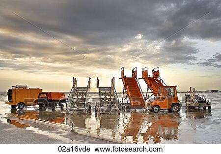 Passenger steps on wet runway View Large Photo Image Stock Image - Passenger steps on wet runway. Fotosearch