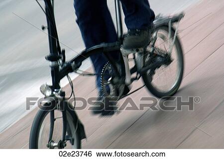Person riding folding bicycle. View Large Photo Image Stock Photograph - Person riding folding bicycle.. Fotosearch