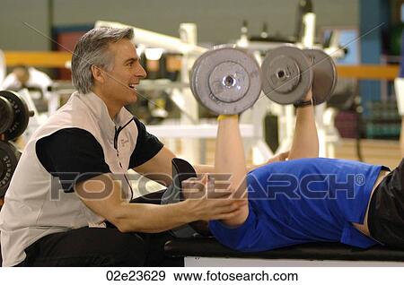 Personal trainer coaching with weights. View Large Photo Image Stock Photo - Personal trainer coaching with weights.. Fotosearch