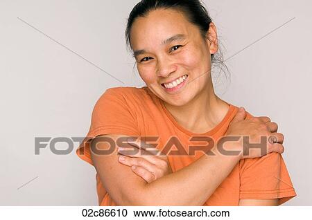 Stock Image - Portrait headshot of happy Asian woman smiling.. Fotosearch