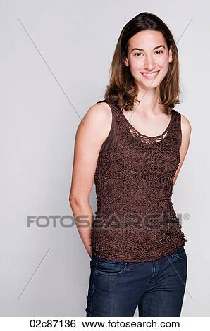 Stock Photograph - Portrait of a smiling young brunette woman.. Fotosearch