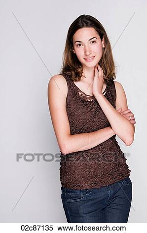 Stock Photography - Portrait of a smiling young brunette woman.. Fotosearch