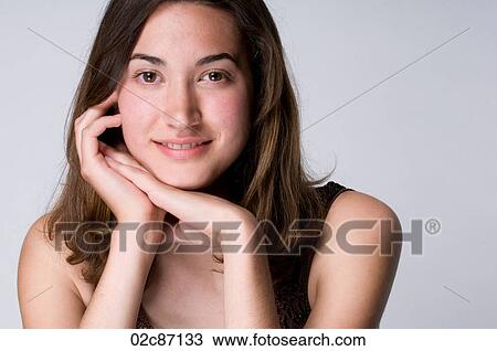 Stock Image - Portrait of a young brunette woman smiling.. Fotosearch