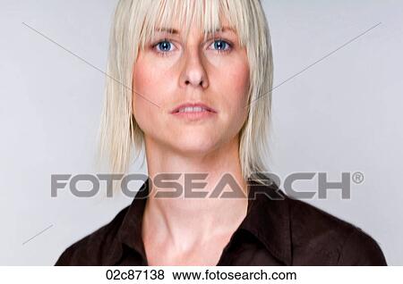 Stock Photo - Portrait of an edgy blonde woman with movement in eyes.. Fotosearch