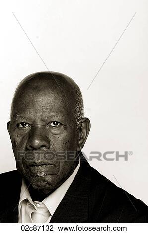 Stock Image - Portrait of an older African-American man in a suit.. Fotosearch