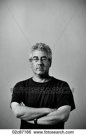 Portrait of middle aged serious man with arms folded. View Large Photo Image Stock Photograph - Portrait of middle aged serious man with arms folded.. Fotosearch