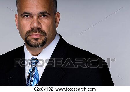 Portrait of serious business man in a suit and tie. View Large Photo Image Stock Image - Portrait of serious business man in a suit and tie.. Fotosearch