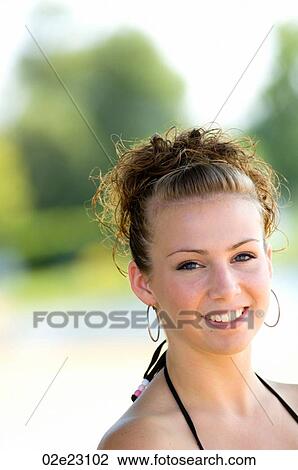 Stock Image - Portrait of teenage girl at the beach.. Fotosearch