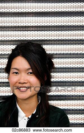 Stock Image - Portrait of young female Asian student.. Fotosearch