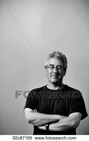 Proud middle aged smiling man with arms folded. View Large Photo Image Stock Photography - Proud middle aged smiling man with arms folded.. Fotosearch