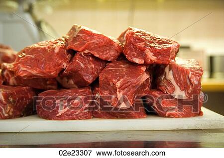 Raw meat on a butcher's cutting board. View Large Photo Image Stock Photo - Raw meat on a butcher's cutting board.. Fotosearch