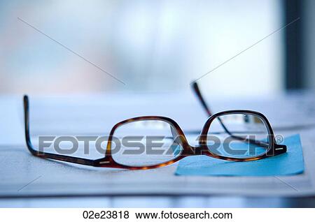 Reading glasses laid on desktop. View Large Photo Image Stock Photo - Reading glasses laid on desktop.. Fotosearch