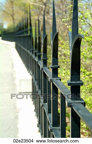 Picture - Receding black metal fence.. Fotosearch