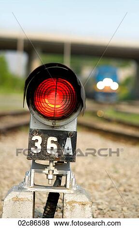 Stock Photo - Red safety warning light beside train railway tracks.. Fotosearch