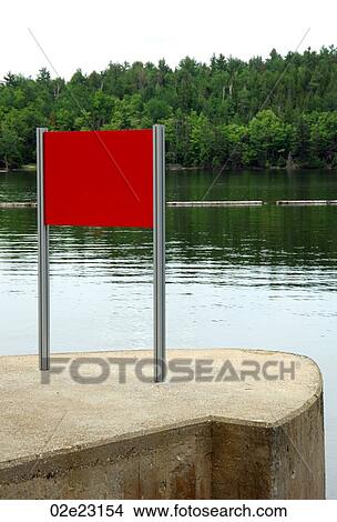 Red sign on waterfront to forest. View Large Photo Image Picture - Red sign on waterfront to forest.. Fotosearch