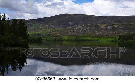 Stock Image - Reflecting lake, Scottish Highlands, Scotland UK.. Fotosearch