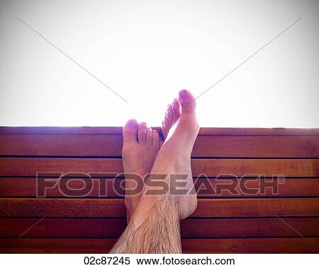 Relaxed crossed feet up on a resort bench. View Large Photo Image Stock Photography - Relaxed crossed feet up on a resort bench.. Fotosearch