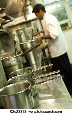 Stock Image - Restaurant kitchen staff busy at work.. Fotosearch