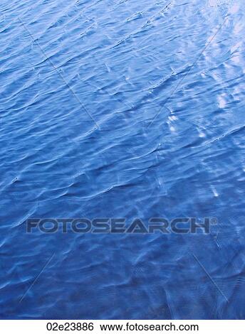 Ripples in blue water. View Large Photo Image Stock Photograph - Ripples in blue water.. Fotosearch