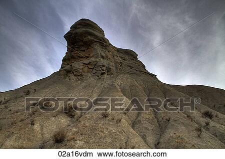 Picture - Rock formation overcast sky. Fotosearch