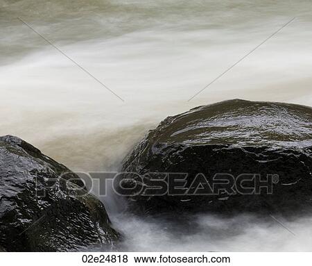 Rocks in water in Bali View Large Photo Image Stock Photo - Rocks in water in Bali. Fotosearch