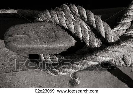 Rope tied to cleat on dock. View Large Photo Image Stock Photo - Rope tied to cleat on dock.. Fotosearch