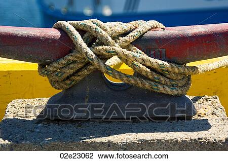 Rope tied to cleat on fishing pier. View Large Photo Image Stock Image - Rope tied to cleat on fishing pier.. Fotosearch
