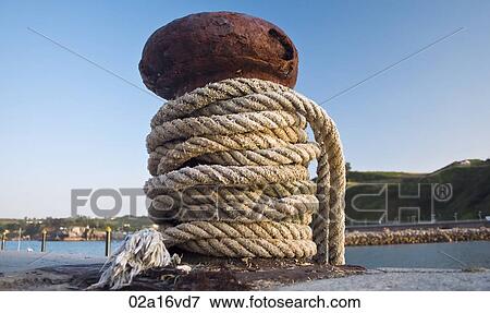 Rope tied to harbour jetty View Large Photo Image Stock Photo - Rope tied to harbour jetty. Fotosearch