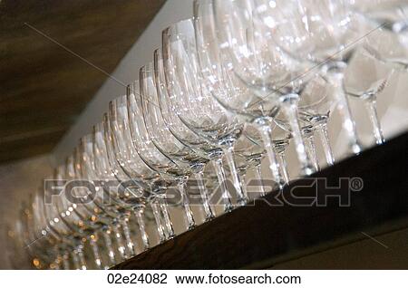Row of empty wine galsses on shelf. View Large Photo Image Stock Image - Row of empty wine galsses on shelf.. Fotosearch