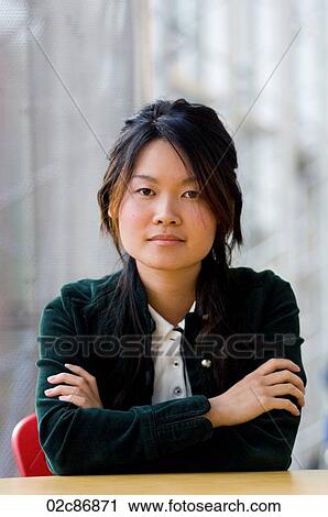 Stock Image - Serious Asian college student.. Fotosearch