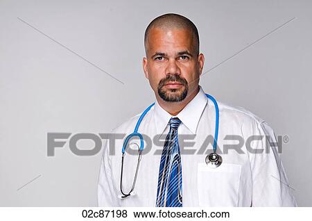 Stock Photo - Serious doctor with stethoscope.. Fotosearch