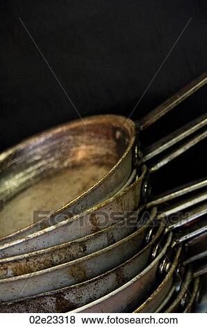 Stock Photo - Several stacked frying pans in commercial kitchen.. Fotosearch