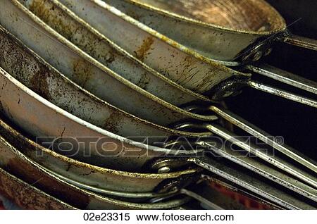 Several stacked frying pans in commercial kitchen. View Large Photo Image Stock Photography - Several stacked frying pans in commercial kitchen.. Fotosearch