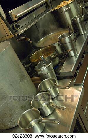 Several steel cooking pots in gourmet kitchen. View Large Photo Image Stock Photo - Several steel cooking pots in gourmet kitchen.. Fotosearch