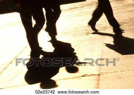Stock Image - Shadows of people walking.. Fotosearch