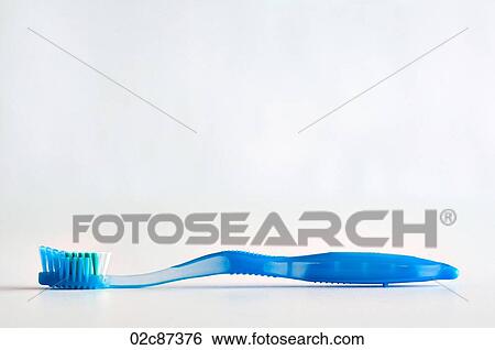 Single blue toothbrush lying face up on a white background. View Large Photo Image Stock Photograph - Single blue toothbrush lying face up on a white background.. Fotosearch