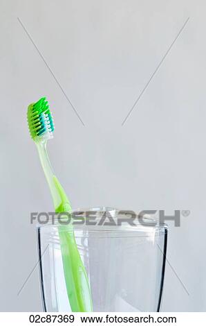Single green toothbrush in bathroom toothbrush holder. View Large Photo Image Stock Photo - Single green toothbrush in bathroom toothbrush holder.. Fotosearch
