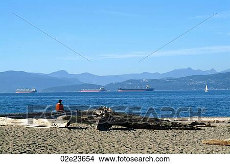 Single person looking out on to the water, Vancouver Canada. View Large Photo Image Picture - Single person looking out on to the water, Vancouver Canada.. Fotosearch