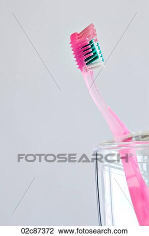 Single pink toothbrush in bathroom toothbrush holder. View Large Photo Image Stock Image - Single pink toothbrush in bathroom toothbrush holder.. Fotosearch