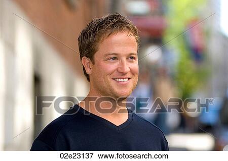 Smiling man looking away from the camera. View Large Photo Image Stock Photo - Smiling man looking away from the camera.. Fotosearch