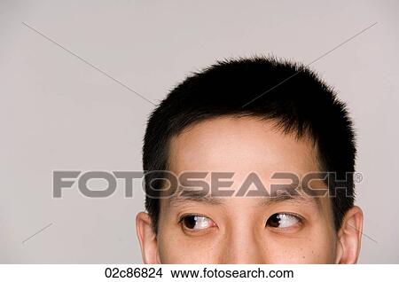 Sneaky Asian man suspiciously peeking. View Large Photo Image Picture - Sneaky Asian man suspiciously peeking.. Fotosearch