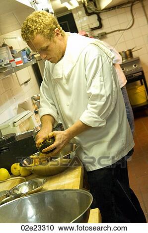 Sous chef prepping food in a busy kitchen. View Large Photo Image Stock Image - Sous chef prepping food in a busy kitchen.. Fotosearch