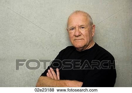 Stock Photo - Stern senior man wearing black T-shirt.. Fotosearch