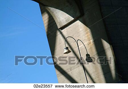 Street light on illuminated cement wall. View Large Photo Image Stock Photo - Street light on illuminated cement wall.. Fotosearch