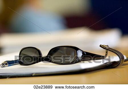 Sunglasses on business daytimer. View Large Photo Image Stock Photo - Sunglasses on business daytimer.. Fotosearch