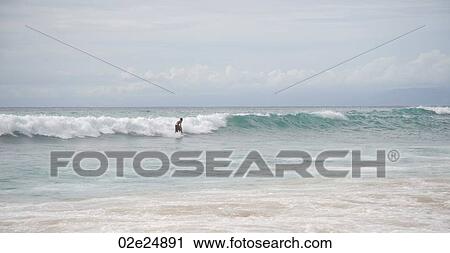 Surfer along coastline in Bali View Large Photo Image Stock Image - Surfer along coastline in Bali. Fotosearch
