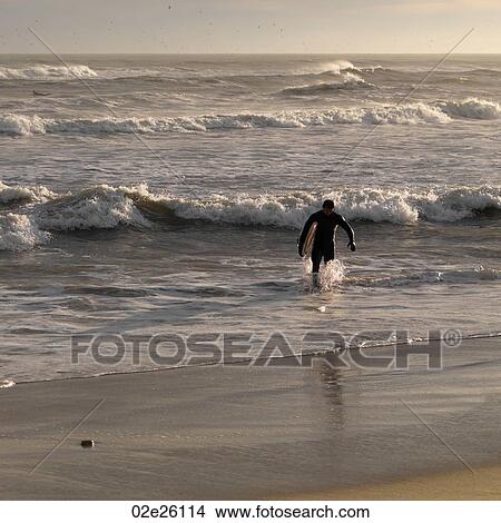 surfer along shoreline at The Hamptons, New York View Large Photo Image Picture - surfer along shoreline at The Hamptons, New York. Fotosearch