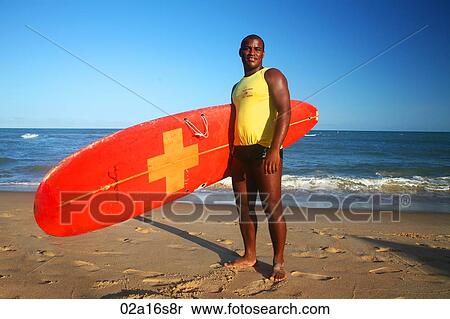 Stock Photography - Surfer on beach. Fotosearch