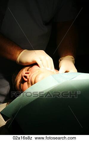 Surgeon examining patients head View Large Photo Image Stock Photo - Surgeon examining patients head. Fotosearch